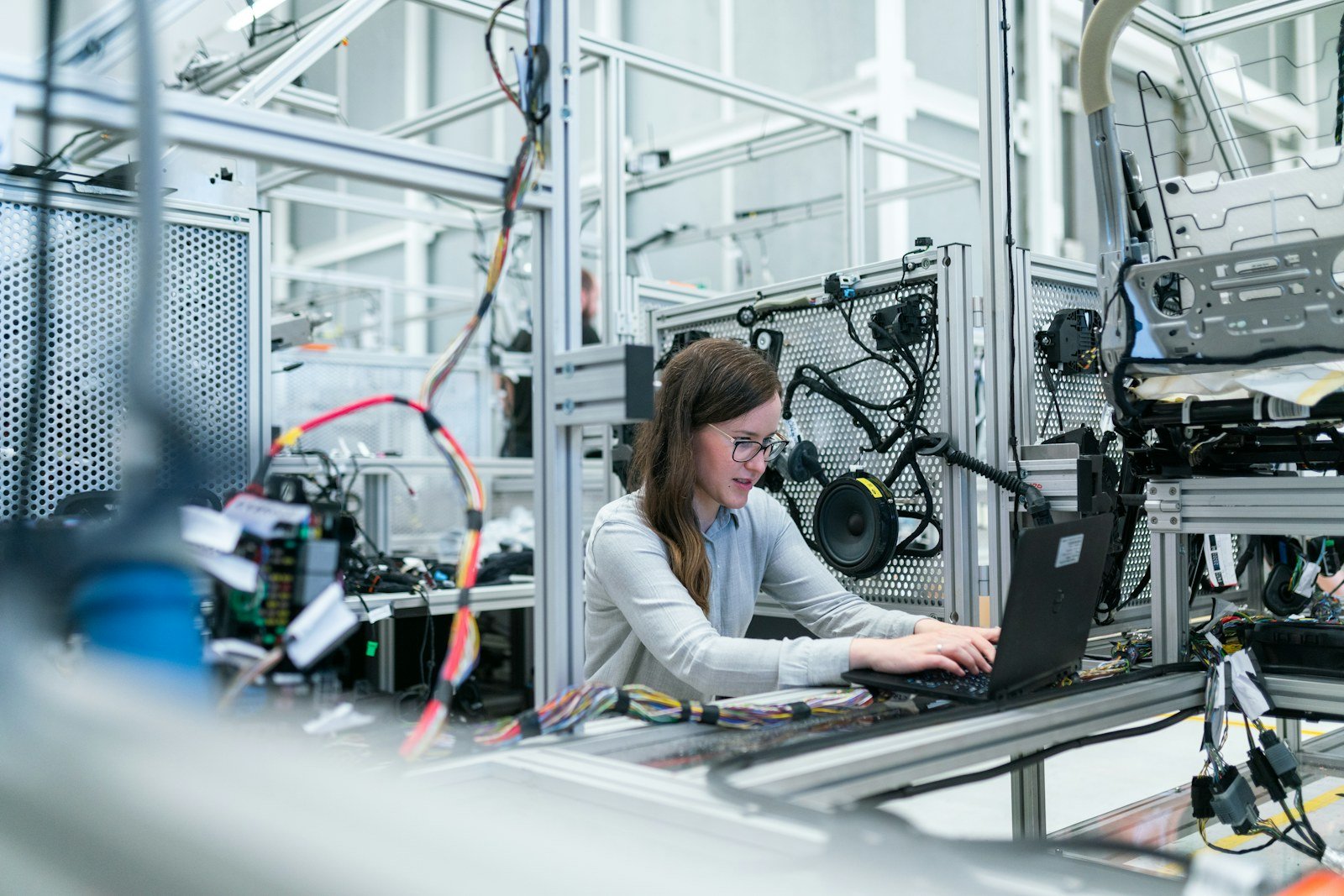 Engineer at a laptop on a production line